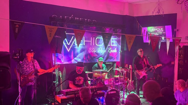 A live band performing under colourful lights at Cafe Metro in Bilston.